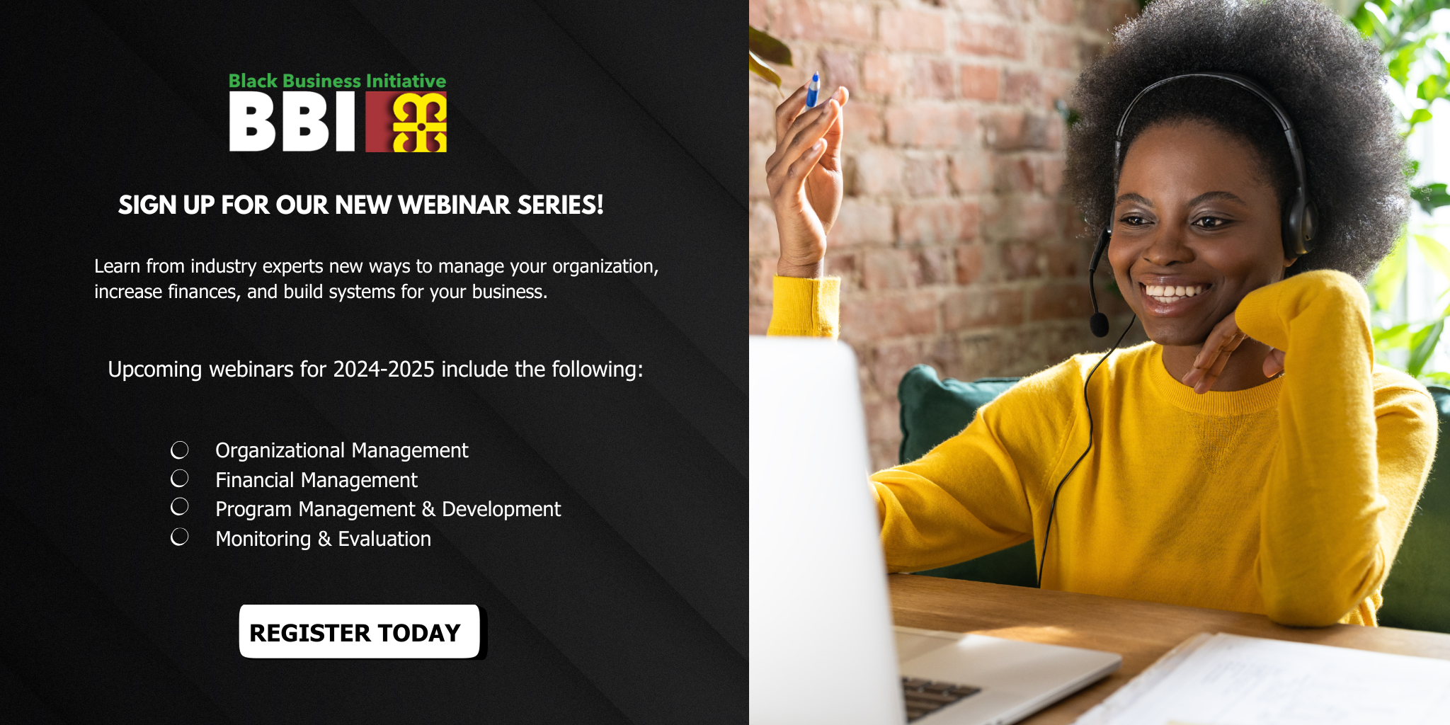 Young smiling black woman in a yellow sweater sitting at a computer. She is wearing headset and looking at the monitor.